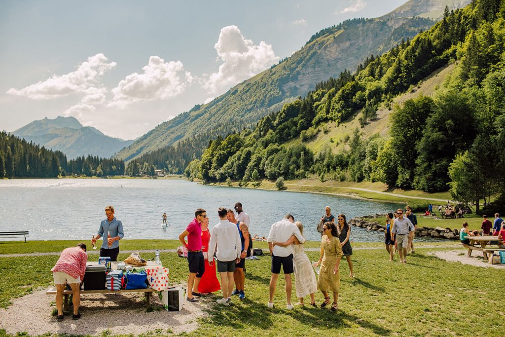 friends having bbq and swimming in lake montriond at the french alps 