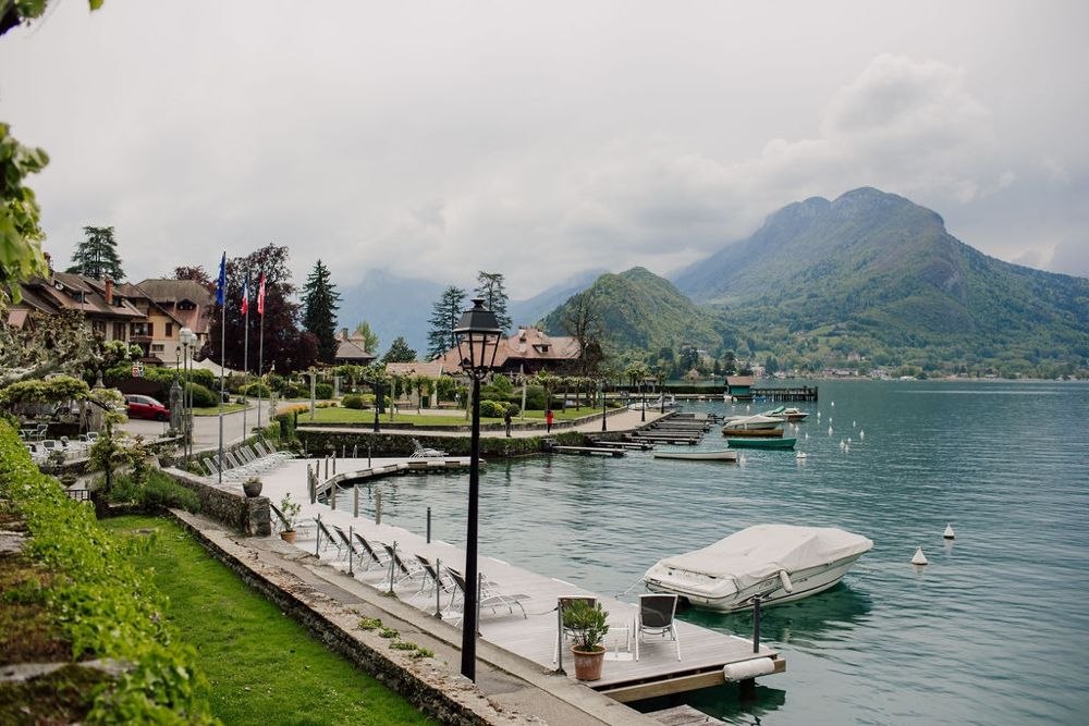 Talloires is a lovely quiet lakeside town near Morzine with small boats afloat by the jetty