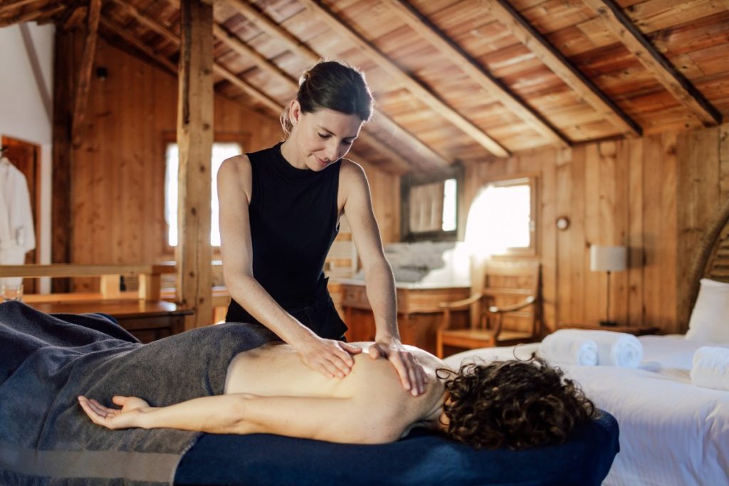 lady having massage during ski holiday inside a hotel room